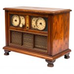 An old, AM radio in a wooden cabinet